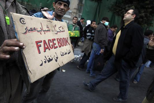 There was a massive turnout by anti-regime protesters as tens of thousands of them showed up in Tahrir Square, Friday, Feb. 4, shouting for Mubaraks departure from the country.  A man holds up a sign for protesters entering the Square that reads Thank You Facebook. 
