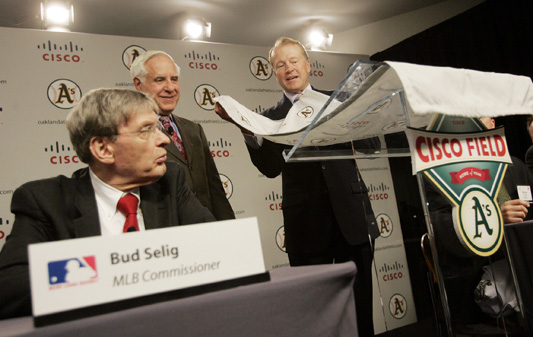 John Chambers, CEO of Cisco Systems (right) unveils the new logo for Cisco Field as Bud Selig (left), Major League Baseball Commissioner and Lew Wolff, Owner and Managing Partner of the Oakland Athletics, watch during a press conference in San Jose on November 14, 2006. The As purchased a 143-acre parcel from Cisco Systems with the intent to construct a new ball park. 