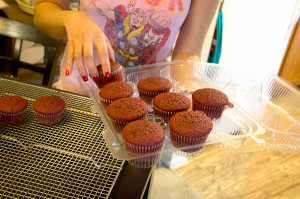 Catherine Golez prepares freshly baked cupcakes for frosting.