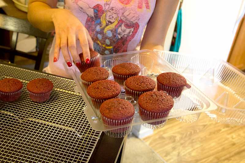 Catherine Golez prepares freshly baked cupcakes for frosting.