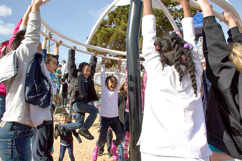 Park  Elementary School children play together on new playground.