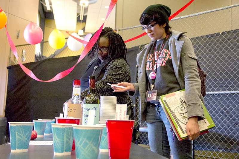 Students learn about alcoholism through messages placed in cups on a beer pong table.