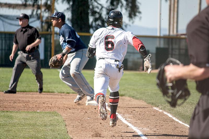 Marcus Wise runs down the baseline attempting to run out a groundball.