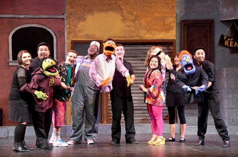 The “Avenue Q” cast poses with their puppets.