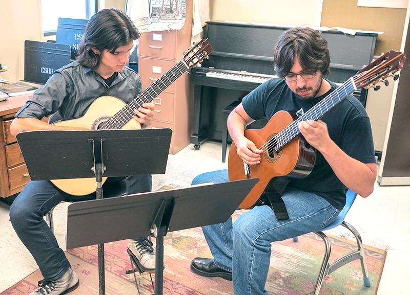 Roberto Granados (left) and Bill White (right) practice their duo.