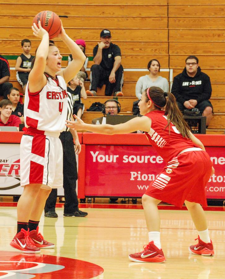 CSUEB guard Shannon Bland attempts to pass the ball against CSUS guard Alysa Valentine Saturday at Pioneer Gymnasium.
