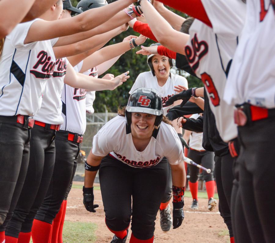 Sophomore+Ali+Cerminara+celebrates+with+her+teammates+after+scoring+a+home+run+Saturday+at+Pioneer+Softball+Field.