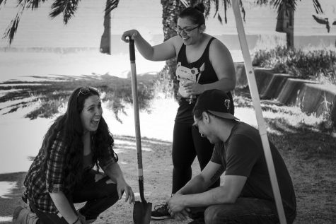 Grad student and squad lead Ashley Schmutzler, left, sits back and cracks jokes with her team Vanessa Armenta, center, and Michael Pacma, right, during a short rest after digging at their sites.