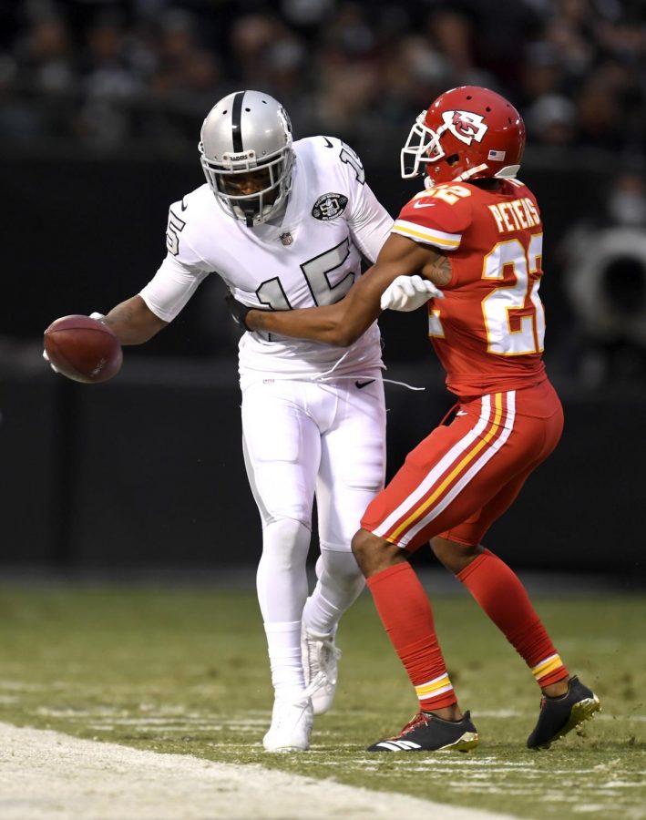 Oakland Raiders wide receiver Michael Crabtree (15) is pushed out of bounds by Kansas City Chiefs cornerback Marcus Peters (22) after making a catch in the first quarter at the Coliseum in Oakland on Thursday, Oct. 19.