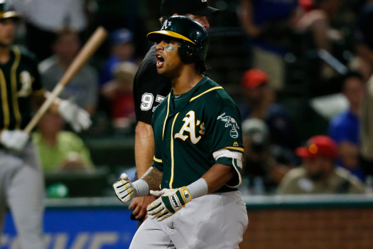 Oakland Athletics Khris Davis celebrates as the crosses home after hitting a three-run home run in the 10th inning of the teams baseball game against the Texas Rangers, Tuesday, July 24, 2018, in Arlington, Texas. The As won 13-10.