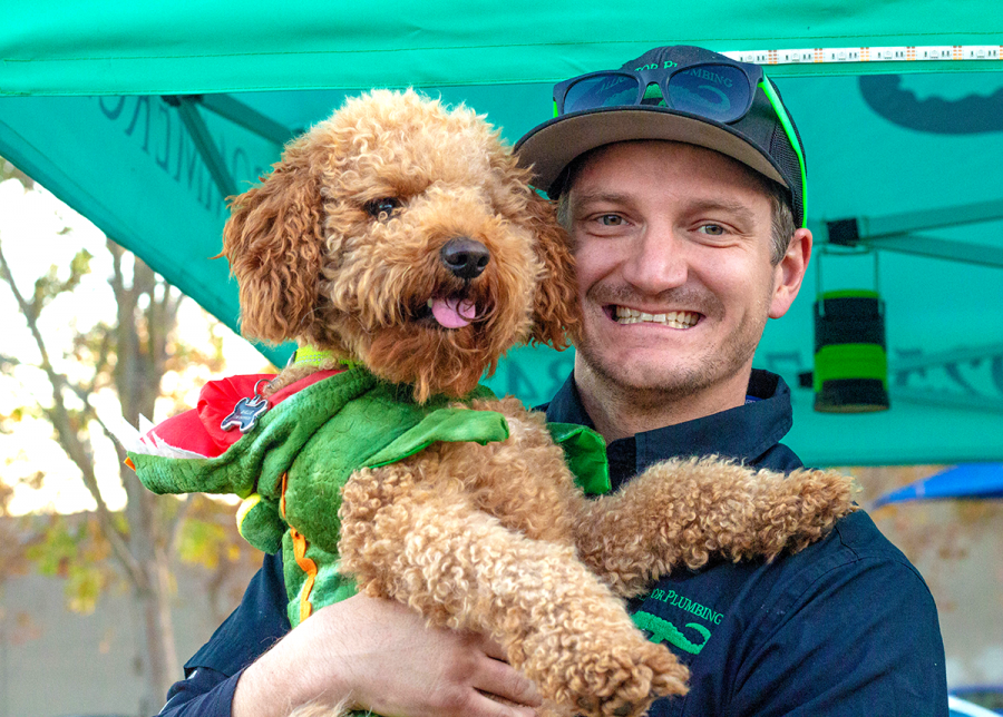 Mike and his furry gator friend Wallie smile while working the Alligator Plumbing booth at the Barks & Boos Festival. 