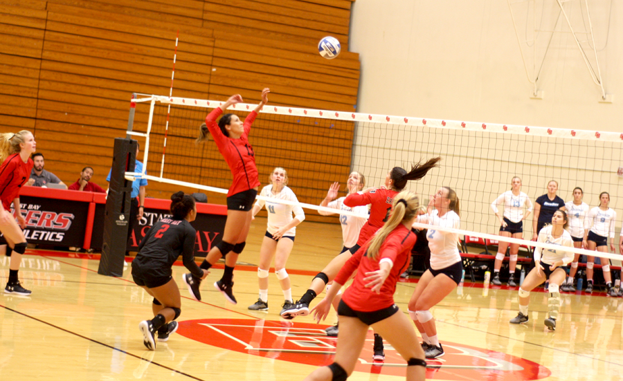 Senior Kathy McKiernan jumps in the air as she records a kill for the Pioneers.
