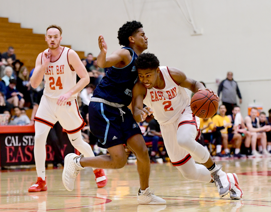 Cal State Eastbay sophomore guard Nai Carlisle dribbles across his opponent during the game against Sonoma State Seawolves held on 16th February 2019 at Pioneer gymnasium, Hayward.