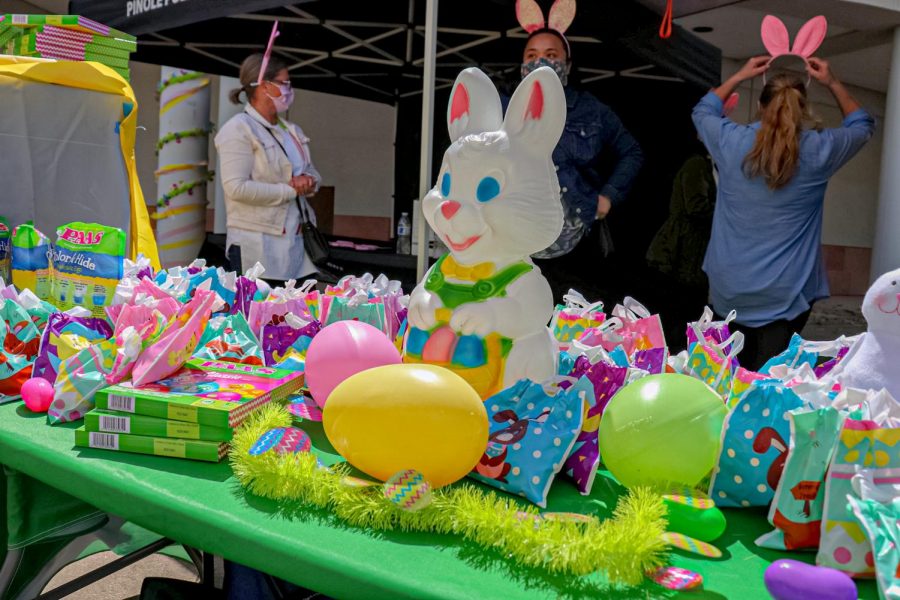  Volunteers for Pinole’s “Drive-Thru Spring Eggstravaganza” hosted by the Pinole Police Department add the finishing touches for the goody bag booth on April 3. 
