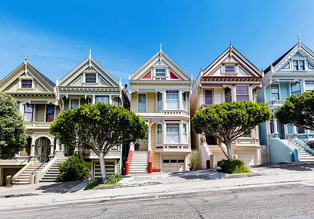 The Painted Ladies of San Francisco, historic victorian style colourful houses under blue summer sky. Alamo Square, San Francisco, California, USA.
