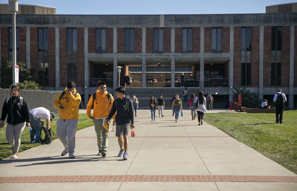 Students walk near Meiklejohn Hall at California State University East Bay (Photo by Anne Wernikoff/CalMatters)