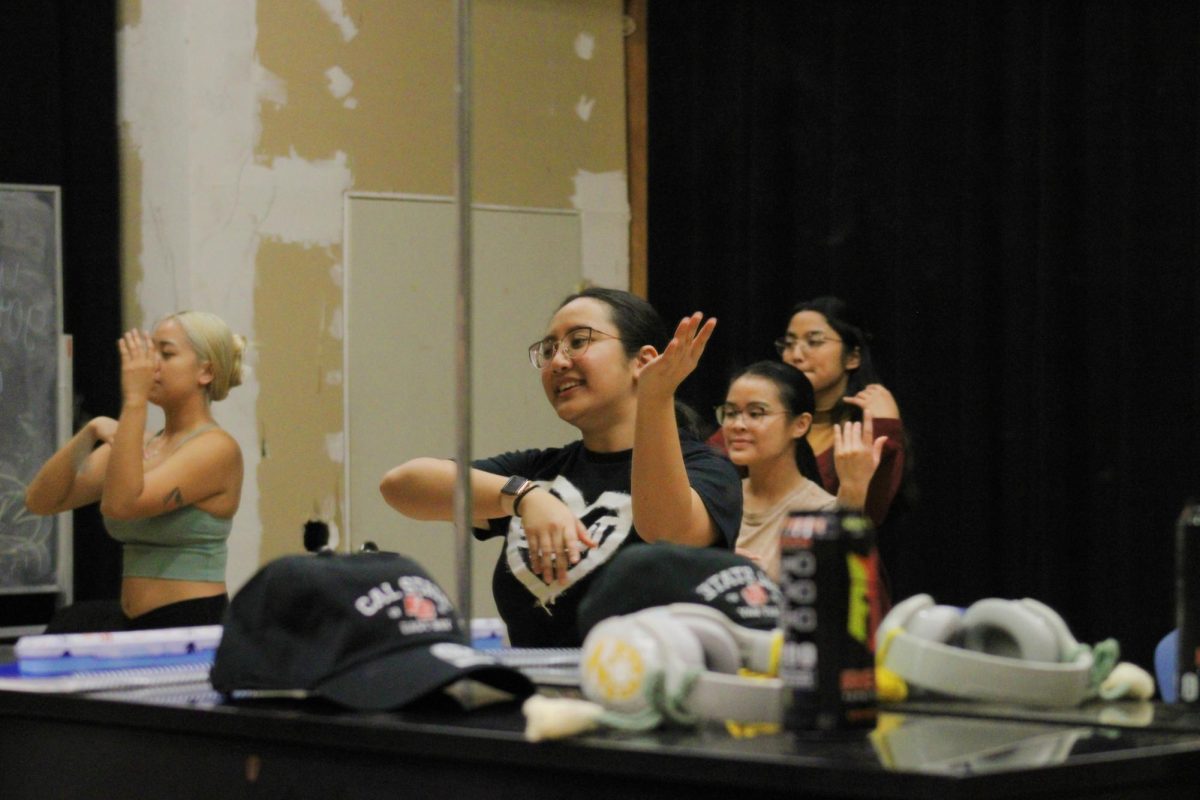 Earlene Escobal leads CSU East Bay students through choreography of the Filipino dance, Pistá 
during a dance workshop at the CSUEB Theatre and Dance building on January 22, 2024.
