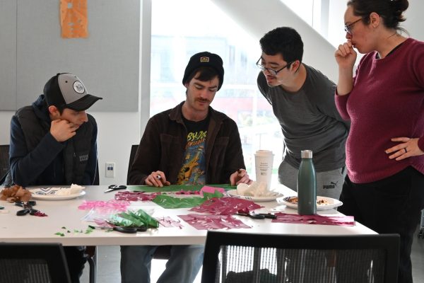 David Valencia, Oscar Thompson, Henry McGuire, and Simone Sisneros-Thiry discussing the Sierpinski gasket during the Math and Mingle event on February 18,2025
