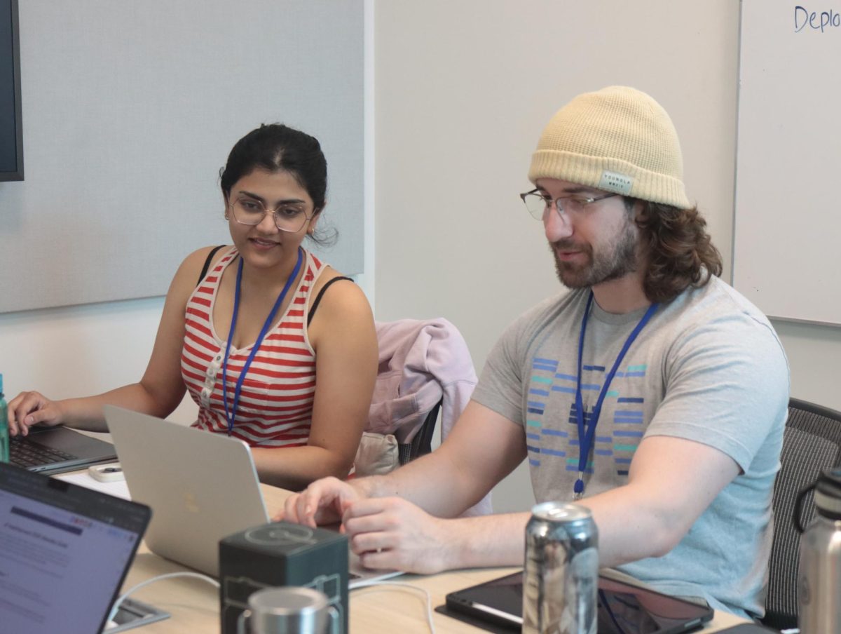 Ananya Makwana (left) and Eugene Lacatis (right) developing a parallel agent for Claude AI during HackHayward 2026.   