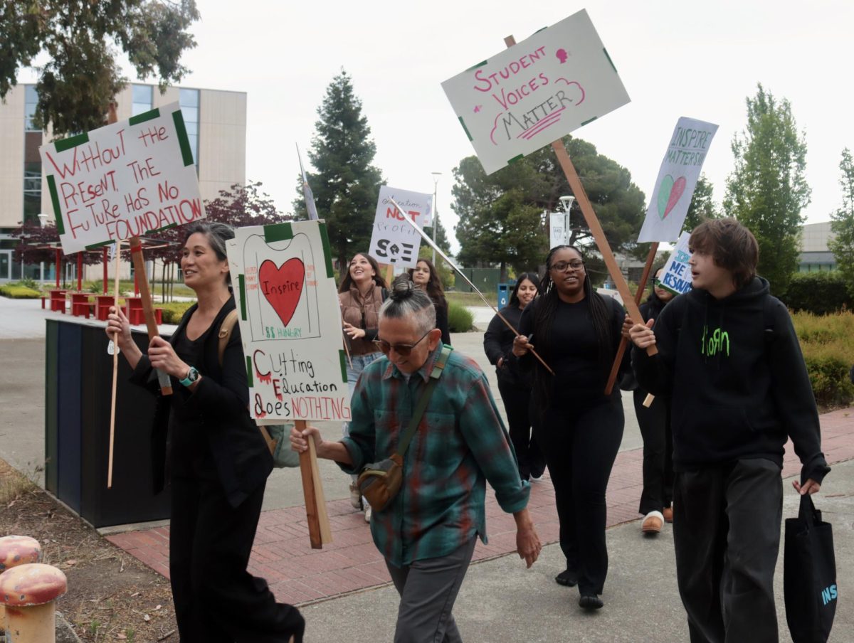 INSPIRE students and faculty march across the CSUEB Hayward campus with picket signs to protest the closure of the program.