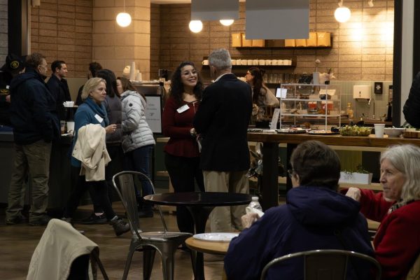 President Misti Short (center left) shares a warm moment with guests during the rainy February mixer at 3Crosses Church.