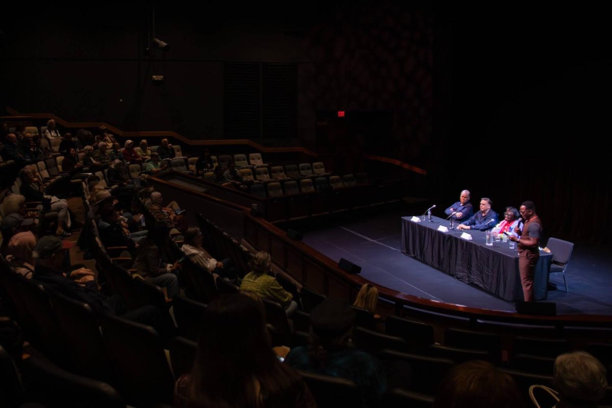 Moderator Linton Johnson guides a post-screening panel with investigative journalists and local editors at Douglas Morrison Theater in Hayward.