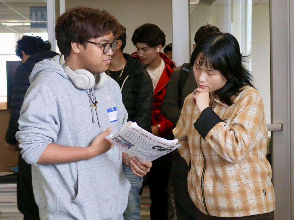 Incoming students arrive at the South Bayview Room of the South University Union to take part in the Immigrant Defense Organizing Fair on May 5, as one student shares information with a volunteer.