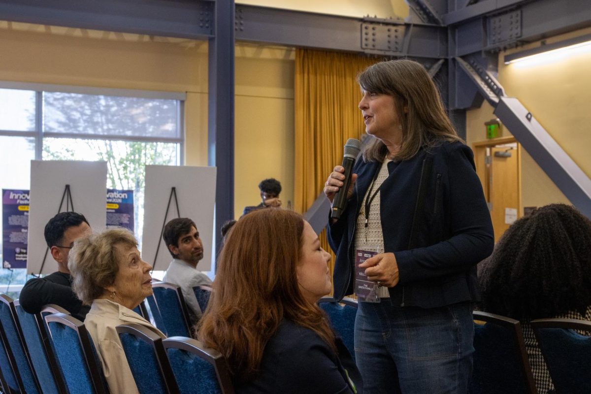 Kelly Cole, executive director of the Owen and Erma Smith Foundation, addresses attendees at Cal State East Bay's Innovation Festival on May 6 as her mother, Erma Smith, co-founder of the Smith Center for Private Enterprise Studies, looks on. Photo by Jerry Chang, founder of Startup East Bay.